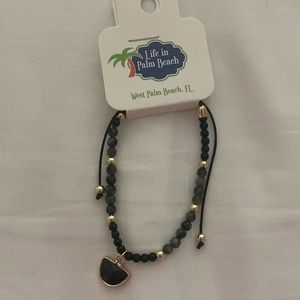 Black beaded corded adjustable bracelet with black faceted charm. NWT